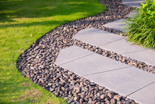 Green lawn, Beautiful stepping stone pathway with green lawn,walkway in the garden, garden landscape design.