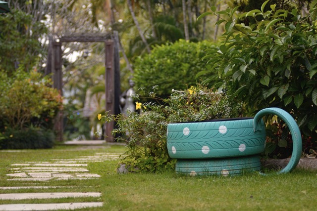 Outdoor garden beside the house increases the green area with a corner to relax.