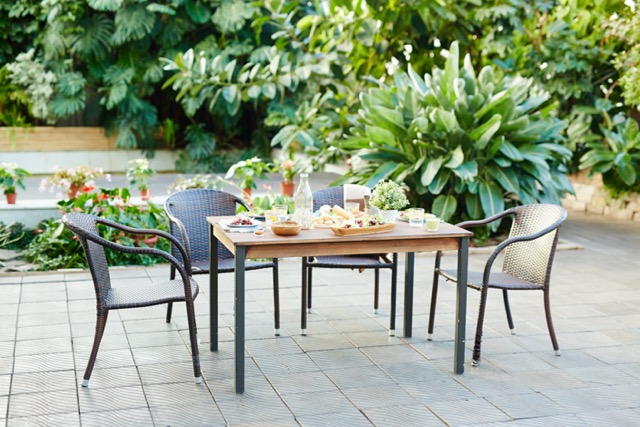 Served table with healthy organic food ready for guests in garden-room